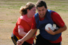 Sophomore Rickey Lopez tries to get away from fellow Sophomore Donna Reed's attempt at pulling his flags during the Young Alum sponsored Turkey Bowl. - Photo by Jonathan Blair