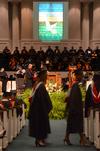 Graduates make their way to the stage to receive their hard-earned diplomas at Union's summer graduation ceremony. - Photo by Beth Spain