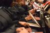 Union graduates take a peek at their recently conferred diplomas at Union's summer graduation ceremony. - Photo by Beth Spain