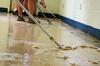Union University volunteers removed nearly eight layers of wax from the cafeteria floor at Lloyd Wood Middle School in Northport, Ala. - Photo by Beth Spain