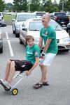 Sophomore Peter Riggs rides a dolly cart pushed by Ben Wright, sophomore dms major, during New Student Move-in. - Photo by Jacob Moore