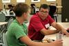 Andrew Tiger, professor of management, talks with Noah Moyers, freshman business major, during Dinner with your Department in the Carl Grant Event Center. - Photo by Deanna Santangelo
