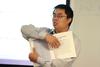 Haifei Li, associate professor of computer science, points out a chapter in the textbook for his class.  - Photo by Kristi McMurry