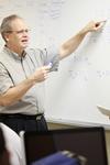 8/30/11 - James Kirk, associate professor of computer science, shows students how to work a problem on the board. - Kristi McMurry