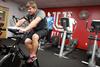 Cooper Rawls, senior PEWS major, works out on a bike in the Wellness Center.   - Photo by Kristi McMurry