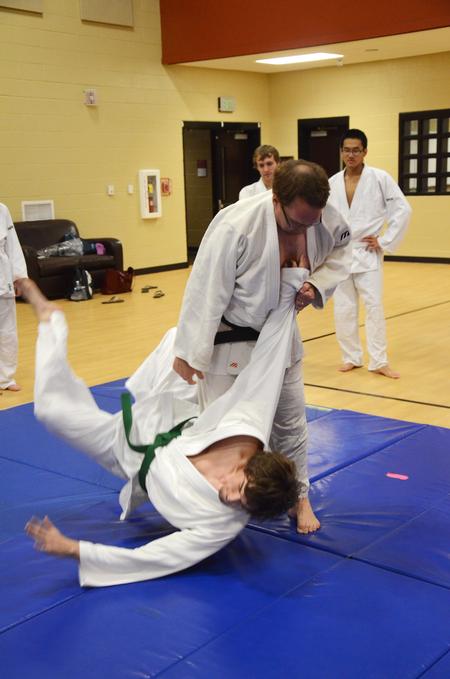 Patrick Parker, Judo master, throws Tyler Hardee, senior chemistry major, during as an example throw for other students in the club.