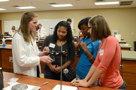 Pharmacy student Ashley Pugh explains a demonstration to prospective students visiting the School of Pharmacy.