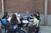 Pam Sutton, professor of English, talks to her students on the patio of Barefoots Joe.  - Photo by Anne Richoux