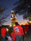 Union students and friends hold candles to honor the families as they walk by during the the fourth annual Remember Me Walk.  - Photo by Morris Abernathy