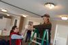 Kate Allen and Amanda Chambers, senior art majors, clean out light fixtures at Pleasant Plains Baptist Church during Campus and Community Day, an annual event where the Union community does service projects around Jackson. - Photo by Jacob Moore