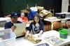 Jordan Haskins, junior computer science major, and Caitlin Roach, senior history major, help archive documents and photos at the Bemis Mill Village Museum during Campus and Community Day.  - Photo by Zac Calvert