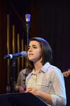 Natalie Wittman,senior spanish major, leads the crowd in a song during chapel. - Photo by Zac Calvert