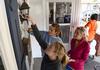 McKenzie Masters (front), sophomore journalism major, paints around a light fixture with Brittney Teal, sophomore nursing major, and Kenley McQuiston, sophomore nursing major, during a service project with Sophomore Council. - Photo by Jacob Moore