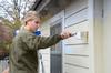 Sophomore Megan Nettle paints the side of a house during a service project with Sophomore Council. - Photo by Jacob Moore