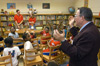 Following a demonstration by Neil Jackson (rear, left) and Sarah Perlinger, both chemistry majors, Dr. Charles M. Baldwin (far right), professor of pre-medical studies, explains the science behind the chemical reaction they have just viewed to second grade students at Whitehall Enhanced Community School on Friday. Union students take chemical demonstrations to students in east Jackson elementary schools through a grant from the American Chemical Society. - Photo by Jim Veneman
