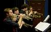 Chase Techentin, senior music major, plays trumpet alongside other members of the Jazz Band during a concert held in the W.D. Powell Theatre. - Photo by Jacob Moore