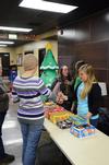 Megan Moore, junior nursing major, receives a mark for candy from a member of SAC as she enters Movie in the Bowld where students watched How the Grinch Stole Christmas. - Photo by Zac Calvert