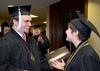 Rob Simpson, digital media studies graduate, and Kristen Marks, art graduate, talk in line prior to going into Union's Fall Commencement Services held at West Jackson Baptist Church. - Photo by Ebbie Davis