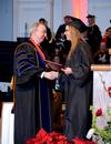David S. Dockery, president of the university, presents Lindsey Bock, biology graduate, with her diploma at the 2011 Fall Commencement Services. - Photo by Ebbie Davis