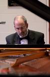 Terry McRoberts, university professor of music, warms up before his faculty piano recital in Hartley Hall. - Photo by Jacob Moore