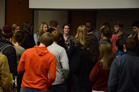 Kylie McDonald, junior political science major, talks with Student Senate members following a senate meeting.