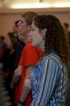 Betsy Marsch, sophomore art major, sings along during chapel. - Photo by Anne Richoux