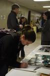 Sam Howard, junior chemistry major, signs up for more information at the external study fair in the Penick Academic Complex.  - Photo by Anne Richoux
