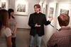 Steve Halla, assistant professor of art, talks with students about his woodcuts on display in the art gallery. - Photo by Kristi McMurry