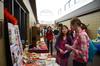 Kendra Loh, sophomore psychology major, shows Ellie Parks, freshman nursing major, a display about Malaysia during CultureFEST. - Photo by Zac Calvert