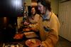 Anna Marie Deschenes, junior social work major, prepares her plate at the home of Ashley Jackson, resident director, during Be Our Guest. - Photo by Ebbie Davis