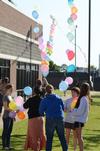 Art department students work together on an arch of balloons stretching from the Penick Academic Complex to Miller Tower. - Photo by Jacob Moore