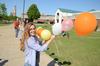Nicole Haynes, junior psychology major, works with members of the art department to take down an arch of more than 1,600 balloons that floated over campus. - Photo by Jacob Moore
