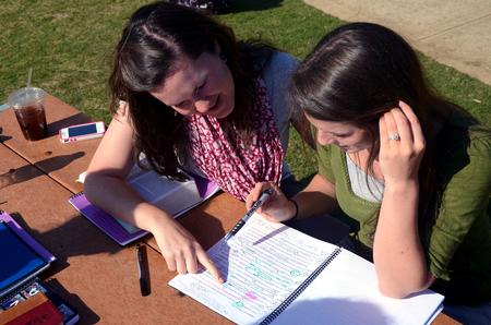 Rachel Ware, director of discipleship, talks with Courtney Allen, senior social work major, about scripture passages for Klemata, a bible study program for female students. 