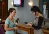 Michelle Lee, sophomore business management major, greets Emily Rich, junior elementary education major, while swiping her identification card for chapel credit. - Photo by Jacob Moore