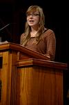 Cari Phillips, senior public relations major, speaks in chapel about her G.O. trip to Memphis.  - Photo by Anne Richoux