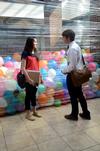 Hillarie Kerr, junior business management major, talks with Andy Seaton, senior Christian studies major, beside a balloon art project in the Student Union Building.  - Photo by Anne Richoux