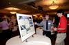 Joel Ingram, junior mechanical engineering major, talks with Georg Pingen, assistant professor of engineering, about his research project for the Scholarship Symposium. - Photo by Anne Richoux