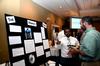 5/1/12 - Alex Charles, sophomore engineering major, talks with George Moss, associate professor of mathematics, about his research project during the Scholarship Symposium poster presentations.  - Anne Richoux