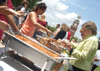 First Lady Lanese Dockery (right) and several graduates and their families enjoyed the graduation luncheon in the grove. - Photo by Jonathan Blair