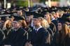 Graduates Alex Brown and Josh Brown, both journalism, and Chelsea Carrier, English, listen to the commencement address during spring graduation.
 - Photo by Zac Calvert