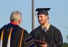Colby Stinebaugh, art graduate, receives his diploma from David S. Dockery, president of the university, during spring graduation. 
 - Photo by Zac Calvert