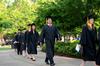 Graduates walk to the Great Lawn as spring graduation begins. - Photo by Anne Richoux