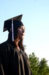 Shinae Giffin, art graduate, waits patiently to receive her diploma during spring graduation.  - Photo by Anne Richoux
