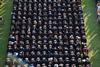 614 excited graduates wait to receive their diplomas during spring graduation on a gorgeous summer evening.  - Photo by Kristi McMurry