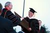 William Latimer, III, receives an honorary doctor of humanities degree during spring graduation. - Photo by Kristi McMurry