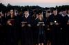 Caroline Beffa, Reed Benson, Margaret Brinson and Alex Brown join the crowd in singing the alma mater to conclude spring graduation.  - Photo by Ebbie Davis