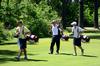 Andy Rushing (middle), head golf coach, walks across the golf course while coaching his players.  - Photo by Zac Calvert