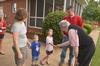 David S. Dockery, president of the university, greets Tim Ellsworth, assistant vice president for university communications and director of media relations, Sarah Ellsworth and their children at the ice cream social hosted for new students. - Photo by Morris Abernathy