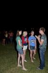 Will Harman (right), junior music major, tells a story to Kim Chesney, junior history major, Katelynn Corden, junior history major, and Anna Lewis, junior tesl major, during the Howdy Party. - Photo by Anne Richoux