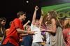Joey Davis, junior business administration major, and Shea Wingate, junior political science major, battle during a paper-rock-scissors tournament as Jake Ryan, senior business administration major, celebrates winning a match in the background during the annual SAC game show.  - Photo by Zac Calvert